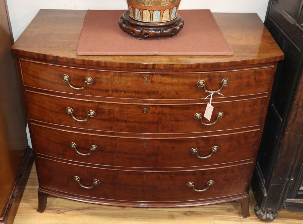 A George III mahogany bowfront chest of four long drawers, W.107cm, D.68cm, H.90cm